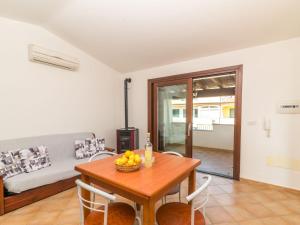 uma sala de jantar com uma mesa e um sofá em Apartment Fertas by Interhome em La Caletta