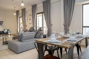 a living room with a dining table and a couch at HiGuests - Fancy 1BR Apt With Aerial Marina Views in JBR in Dubai