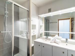a white bathroom with a shower and a sink at Apartment Le Shamrock - Le Lac-6 by Interhome in Tignes