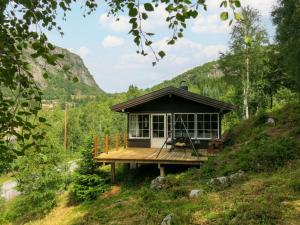 a small cabin in the middle of a hill at Holiday Home Bjørnnåslia - SOW161 by Interhome in Åseral