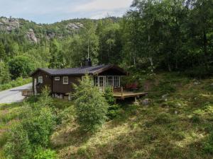 a house on the side of a hill next to a road at Holiday Home Bjørnnåslia - SOW161 by Interhome in Åseral