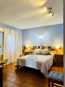 a bedroom with a bed and blue walls at Apartamentos Turísticos Santa Marina in Aracena