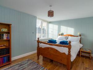 a bedroom with a bed and a book shelf at Apartment Helland by Interhome in Pentewan