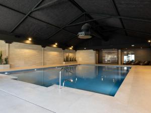 a large swimming pool in a large room with at Holiday Home Citta Romana by Interhome in Hellevoetsluis
