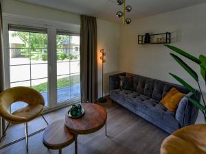 a living room with a couch and a table at Holiday Home Citta Romana by Interhome in Hellevoetsluis