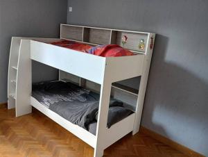 a white bunk bed in the corner of a room at Pont-de-poitte: Appart'Alice in Pont-de-Poitte