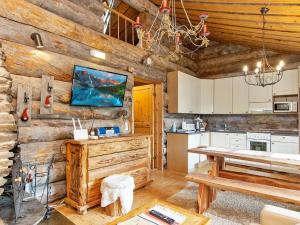 a kitchen with wooden walls and a table in a cabin at Holiday Home Lymys by Interhome in Saariselka