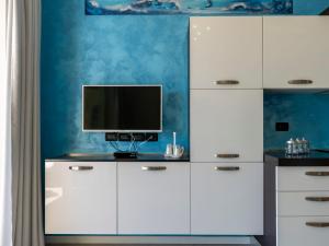 a room with a white cabinet with a television on it at Apartment Blue Moon by Interhome in Santo Stefano al Mare