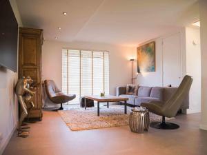 a living room with a couch and a table at Holiday Home Citta Romana by Interhome in Hellevoetsluis