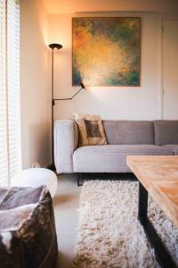 a living room with a couch and a table at Holiday Home Citta Romana by Interhome in Hellevoetsluis