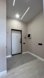 a large white room with a door in it at Cozy 2 room apartment in city center in Almaty