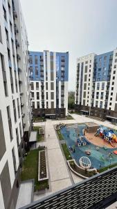 a view of a pool in a city with tall buildings at Cozy 2 room apartment in city center in Almaty