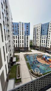 a view of a playground in a city with tall buildings at Cozy 2 room apartment in city center in Almaty