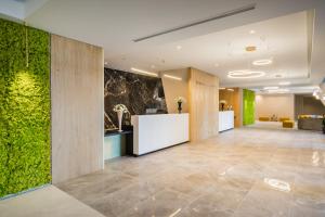 a lobby with a green wall in a building at Barceló Fortina Malta in Sliema