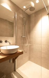La salle de bains est pourvue d'un lavabo et d'une douche. dans l'établissement Appartement N05 Bakboord & Stuurboord, à Oost-Vlieland
