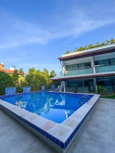 a swimming pool in front of a house at Brisa do Mar Praia Hotel in Morro de São Paulo