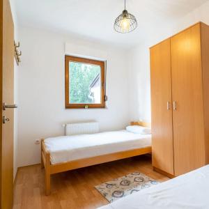 a bedroom with two beds and a cabinet at Apartman Lux Blidinje in Blidinje