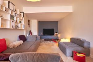 a living room with a couch and a television at Maison chez nous in Izeron