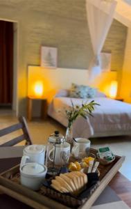 a tray of food on a table in a bedroom at La Serena Suites Aparthotel in La Paloma