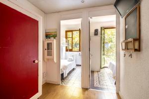 a hallway with a red door leading to a bedroom at Centric Apartments Sagrada Famila 3 in Barcelona