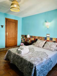 a bedroom with a bed with two towels on it at Apartamentos Turísticos Santa Marina in Aracena +82 photos