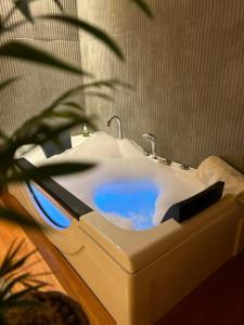a white bathroom sink with a faucet and a plant at La Serena Suites Aparthotel in La Paloma +20 photos