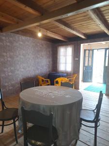 a dining room with a table and chairs and a window at Sholedani in Ambrolauri