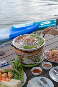 a table with a bowl of food on top of it at Lakeation kanchanaburi in Ban Wang Khun Knachen