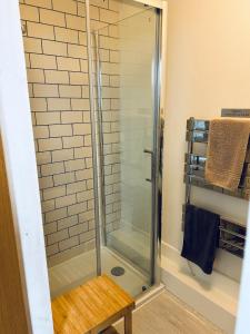 a shower with a glass door in a bathroom at Lochaline Hotel in Lochaline