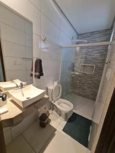 a bathroom with a toilet and a sink at Pousada Maré do Francês in Praia do Frances