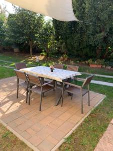 a table and chairs sitting on a patio at Ica Vendégház in Süttő +1 photo