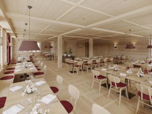 a restaurant with white tables and white chairs at Bergwelten Salwideli in Sörenberg