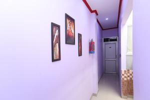 a hallway with paintings on the walls of a house at Hotel Rama Palace in Morādābād
