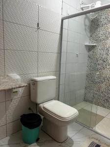 een witte badkamer met een toilet en een douche bij POUSADA LUATOUR Praia Pontal do Coruripe in Coruripe