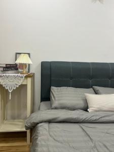 a bed with a blue headboard in a room at The Sugar Barn 1 Bedroom D Perdana Kota bharu in Kota Bharu