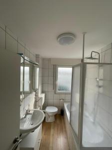 a bathroom with a sink and a toilet and a shower at Rio de Janeiro by estrella24 LIVING ROOMS in Castrop-Rauxel