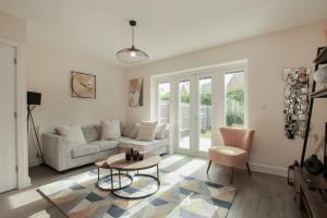 a living room with a couch and a table at Luxury Colchester House in Colchester