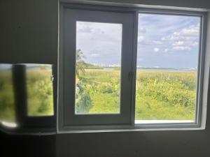 a window with a view of a field of grass at Portobelo in San Juan