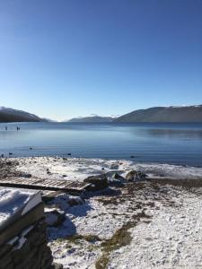 a body of water with snow on the shore at Alba b & b in Inverness