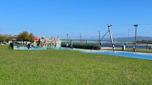 a playground in a park next to the water at FERREIRA'S HOUSE Viana do Castelo in Viana do Castelo