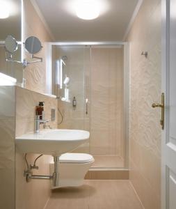 a bathroom with a toilet and a sink and a shower at City Nest Apartments by Adrez in Prague