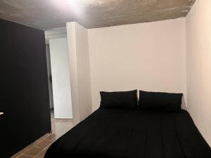 a bedroom with a black bed in a room at Portobelo in San Juan +10 photos