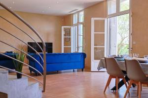 salon z niebieską kanapą i stołem w obiekcie Maison de Maître Centre Ville w Hyères