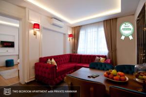 a living room with a red couch and a table at Blue Mosque Suites 2 - Old City Sultanahmet in Istanbul