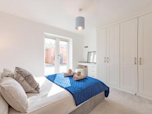 Dois ursos de peluche sentados numa cama num quarto em Pass the Keys Contemporary Apartment with Secure Parking em Shrewsbury