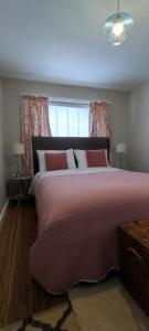 a bedroom with a large bed and a window at The Mews Cottage in Penzance