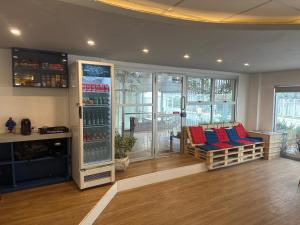 a living room with a refrigerator with red and blue pillows at Hotel Bela Cintra in São Paulo