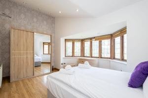 a bedroom with two beds and a large mirror at Pillo Rooms - Abbey Grove in Manchester
