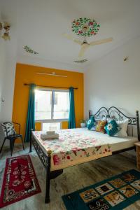 a bedroom with a large bed with blue curtains at Krishna Stay Guest House in Udaipur