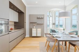 a kitchen and dining room with a table and chairs at Villa Schwan Wohnung 03 in Heiligendamm